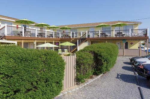 a building with a balcony with chairs and umbrellas at The Ocean Resort Inn in Montauk