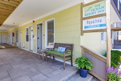 a porch with a bench and a sign for the ocean resort inn at The Ocean Resort Inn in Montauk