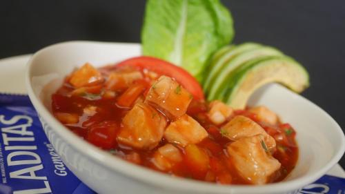 a bowl of food with chicken and tomatoes and avocado at Mishol Bodas Hotel & Beach Club Acapulco Diamante in Acapulco