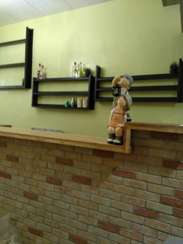 a teddy bear sitting on a shelf in a store at 崗好山莊 in Jianshi