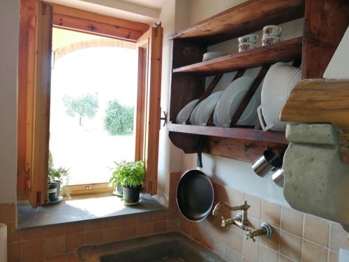 a kitchen with a sink and a window at Casa Pancole in Cavriglia