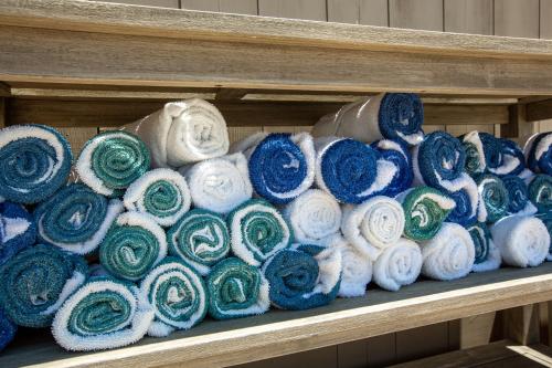 a shelf filled with lots of different colored towels at Aqualina Inn Montauk in Montauk