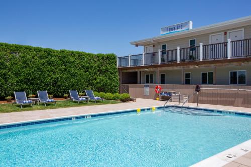 a large swimming pool in front of a hotel at Aqualina Inn Montauk in Montauk