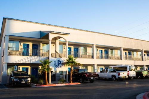a building with cars parked in front of it at Palace Inn El Paso in El Paso