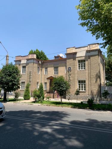 a large brick building on the side of a street at Lion B&B in Samarkand