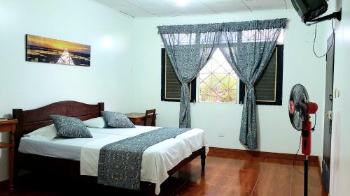 a bedroom with a bed and a window at Hostal Maravilla Amazonica in Iquitos