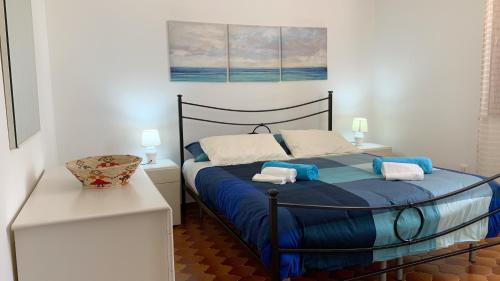 ノート・マリーナにあるFronte spiaggia Lido di Notoのベッドルーム1室(ブルーベッド1台、タオル2枚付)