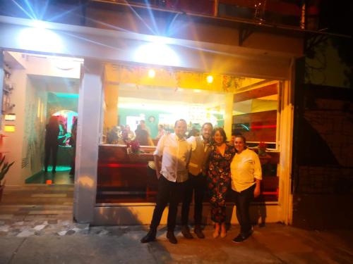 a group of people standing in front of a store at NATIVUS Art-Hostel in San José