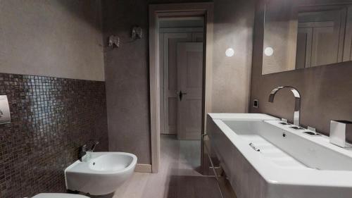 a bathroom with a sink and a toilet at Ille Terrarum in Silvaplana