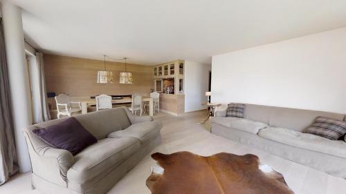 a living room with a couch and a table at Ille Terrarum in Silvaplana