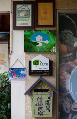 a group of signs on a wall at Rui Li Yinxiang Qu Homestay in Meishan
