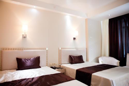 Ένα ή περισσότερα κρεβάτια σε δωμάτιο στο Abnicum Business Hotel
