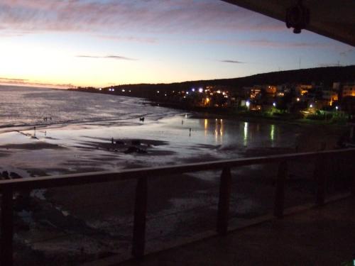 a view of a beach at night with the ocean at taghazout playa in Taghazout