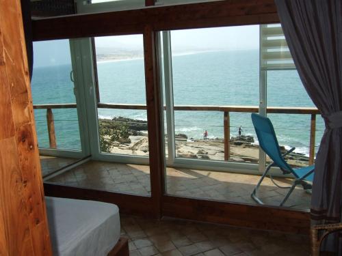 a room with a room with a view of the ocean at taghazout playa in Taghazout