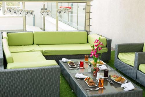 a living room with a couch and a table with food at Executive Residency by Best Western Nairobi in Nairobi
