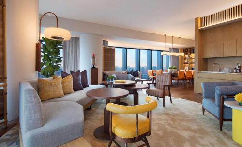 a living room and kitchen with a couch and a table at Andaz Singapore, By Hyatt in Singapore