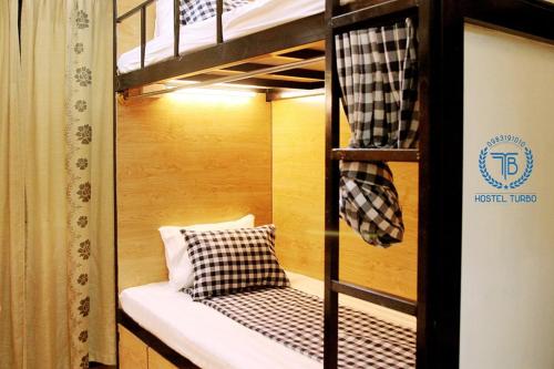 a bunk bed with two pillows on the bottom bunk at HOSTEL TURBO in Hanoi