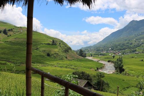 a view of a valley with a river and mountains at SaPa Farmer House in Sa Pa