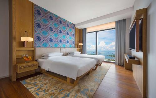 a bedroom with two beds and a large window at Andaz Singapore, By Hyatt in Singapore