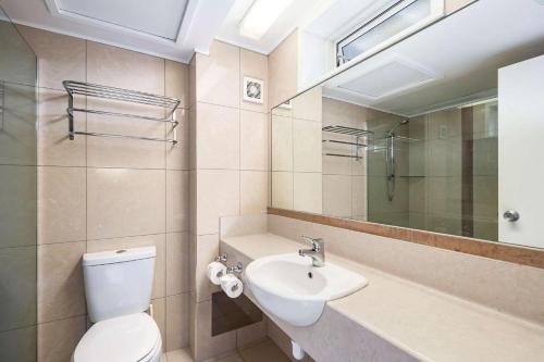 a bathroom with a toilet and a sink and a mirror at Quality Inn Napier in Napier