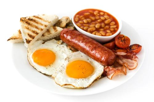 a breakfast plate with eggs bacon beans and toast at M n M Guesthouse In Turfloop Mankweng in Polokwane