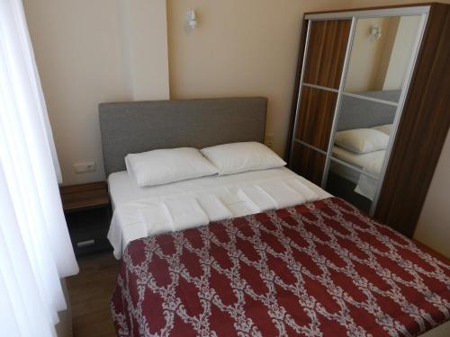 a bedroom with a bed with a red and white blanket at OId Hagia Sophia Pansion in Istanbul