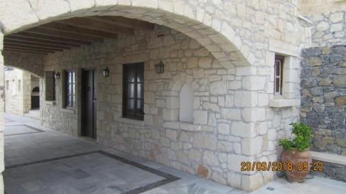 an entrance to a stone building with an archway at Stonehouse villas with breathtaking view in Sitia
