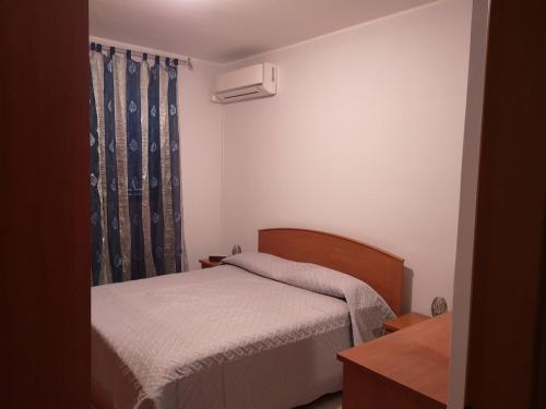 a small bedroom with a bed and a window at Il Castello di Aci in Aci Castello