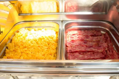 a plastic container of food with meat and rice at Hotel Portas De Santa Rita in Ermesinde