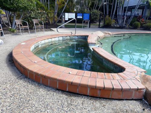 a small pool with a brick around it at Gorgeous Apartment in Luxurious Noosa Resort in Noosaville