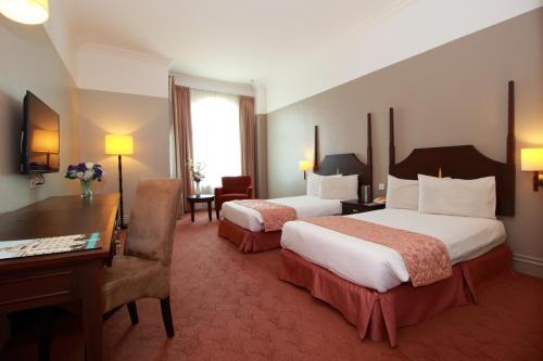 Postel nebo postele na pokoji v ubytování Grand Kampar Hotel