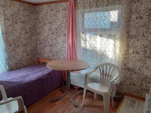 a bedroom with a bed and a table and chairs at Comfort flat & parking Gertrudes Street Riga in Riga