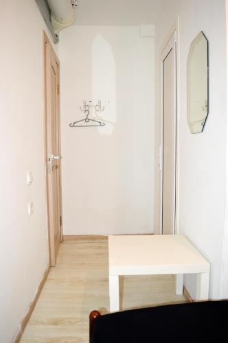 a white room with a table and a mirror at Hostel Train Station in Kyiv