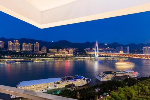 a view of a river with two boats in it at King'sLandind BnB in Chongqing