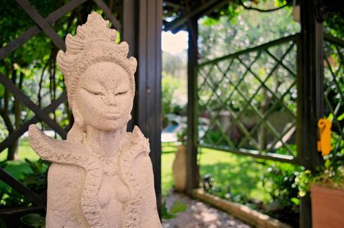 a statue of a person with their eyes closed at Hotel Erika in Malcesine