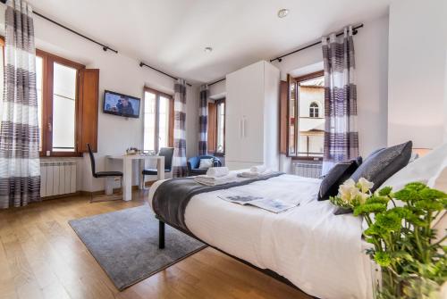 a bedroom with a large bed and a dining room at Sant'Angelo Apartments in Rome