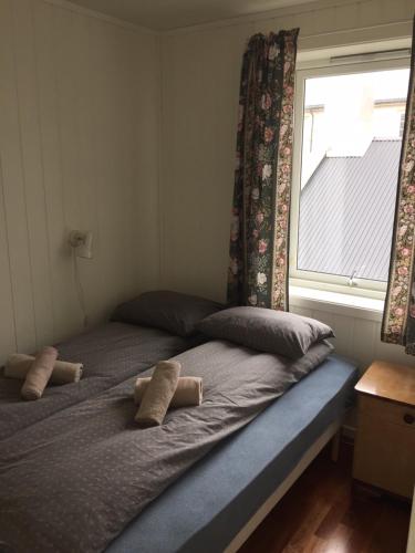 two beds in a room with a window at Lovely 3 rooms apartment for holiday in Nyksund in Nyksund