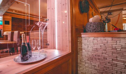 a counter with wine bottles and glasses on it at Gasthof Schmalzerhof in Weer