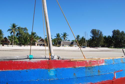 a blue and red boat sitting on the beach at Vilancool Beach Resort in Vilanculos