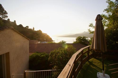 an umbrella sitting on a balcony next to a building at Hôtel Sampiero in Propriano