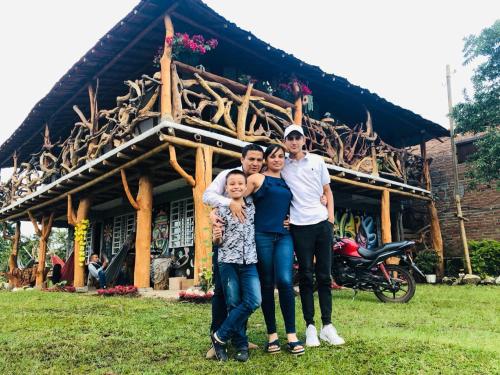 a family posing in front of a house at Cabañas Guacari San Agustín huila in San Agustín
