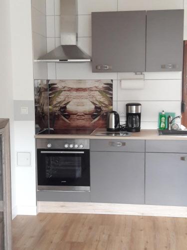 a kitchen with a stove and a stove top oven at Ferienwohnung in Gadsdorf
