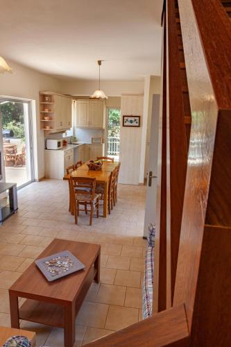 a kitchen and living room with a table and a dining room at VillaEvaNafplion in Paralía Iríon