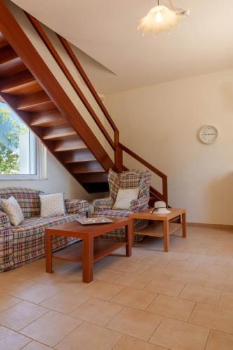 a living room with a couch and a table at VillaEvaNafplion in Paralía Iríon
