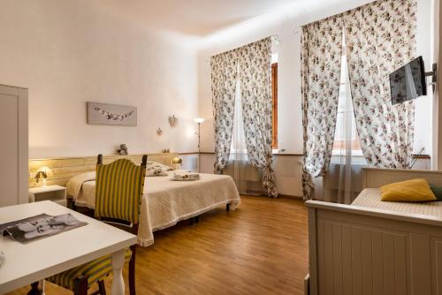 a room with two beds and a table and chairs at B&B San Remigio in Florence