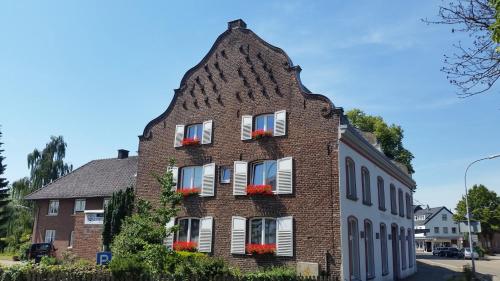 a brick building with flower boxes on the windows at Hotel zur Brücke in Kevelaer