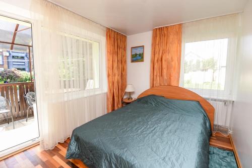 a bedroom with a bed and a large window at Holiday Palanga Sea Side in Palanga