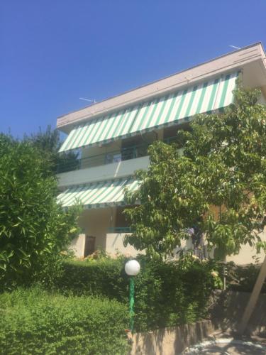 a building with a street light in front of it at Pararse Apartments in Vlorë