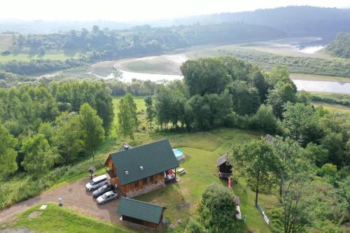 an aerial view of a house on a hill with parked cars at U Malwiny in Rajskie Sakowczyk