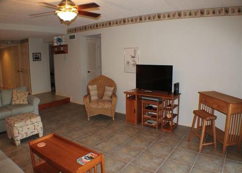 a living room with a couch and a television at Summerhouse 228 Condo in Saint Augustine